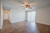 Located in the Plantation neighborhood of Olive Branch, Mississippi, this single-story home offers a well-organized layout with a clean, neutral aesthetic throughout. Rich wood-look flooring flows through the main living and dining areas, reflecting natural light and lending warmth to the open spaces. The dining area is accented by an elegant chandelier, while an arched passageway connects it to the living room, which features a ceiling fan and a sliding glass door that allows views of the outdoors and fills the space with natural light.

The kitchen is thoughtfully equipped with white cabinetry accented by light wood trim, offering generous storage through both upper and lower cabinets. White appliances include a range, dishwasher, and refrigerator, complemented by a double sink and a dedicated pantry closet nearby.

The bedrooms are finished with plush carpet and ceiling fans, providing a comfortable retreat. One bedroom features an attached bathroom area with a vanity and walk-in closet, while a full bathroom includes a tub-shower combination and wood-look flooring. Additional closet space is integrated throughout the home, enhancing practicality. Textured ceilings and consistent white walls create a bright, cohesive ambiance across all rooms.