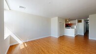 Located at 901 Draper Ave in Schenectady, NY, this two-bedroom, one-bathroom residence offers a well-organized single-floor layout. The open-concept living room is a bright and welcoming space, featuring warm hardwood-style flooring and large windows that usher in generous natural light and outdoor views. This area flows seamlessly toward the kitchen, which is configured in a galley style with rich dark wood cabinetry, laminate countertops, a stainless steel refrigerator, built-in dishwasher, and overhead pendant lighting that adds a functional yet tasteful touch.

Both bedrooms are comfortably sized and finished with plush carpeting for a cozy feel. Each room includes frosted-glass interior doors that allow light to pass through while maintaining privacy. Two dedicated closets—each carpeted and equipped with wire shelving systems—provide practical storage throughout the home.

The bathroom is clean and straightforward, featuring a full-size soaking tub with a shower combination set against bright white surround walls and chrome fixtures. Neutral tones are carried throughout the entire residence, contributing to a cohesive and move-in-ready aesthetic. The overall layout is efficient and functional, making thoughtful use of the available square footage.