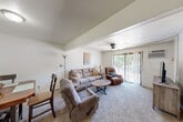 Located at 4201 Valley Forge Road in Mount Vernon, Illinois, this two-bedroom, one-bathroom single-floor residence offers a functional and comfortable layout across a compact footprint. The living room serves as the heart of the home, featuring plush carpeting, a ceiling fan, textured ceilings, and a sliding glass door that invites natural light and provides views of the outdoors. The open connection to the dining area creates an easy flow between spaces, with the dining room offering its own overhead lighting and carpeted floors. The kitchen stands out with its distinctive teal-blue cabinetry, light countertops, wood-look vinyl flooring, and a drop ceiling with fluorescent lighting, giving it a characterful, retro-inspired feel. A stainless steel refrigerator and ample cabinet storage complete the space. The primary bedroom is a comfortable retreat featuring an expansive wall of louvered bifold closet doors offering generous storage, carpeted floors, and a window with vertical blinds. The full bathroom includes a tub-shower combination, wood-look vinyl flooring, and a tile-paneled ceiling. A hallway connects the private areas of the home, rounding out this well-organized and practical residence.