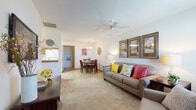 Located on Sugar Maple Loop N in Huber Heights, Ohio, this single-story home offers a well-organized layout designed for comfortable everyday living. The living room serves as the heart of the home, featuring plush carpeting, a ceiling fan, and natural light from nearby windows dressed with patterned curtains and blinds. Framed artwork adorns the walls, contributing to a warm, welcoming ambiance throughout.

The living space flows naturally into a dedicated dining area, which features tile flooring and an overhead chandelier that provides focused illumination for meals. Adjacent to the dining area, the kitchen is fully equipped with rich wood cabinetry, ample counter space, tile flooring, and white appliances including a refrigerator, range, microwave, and dishwasher.

The primary bedroom is generously sized, showcasing carpeted floors and multiple windows that allow for plentiful natural light. A second bedroom also includes carpeting, a closet, and a window. The bathroom features tile flooring, a marble-topped vanity, and a tub-shower combination, with the added convenience of an in-unit washer included in the space.

Completing the home is an attached single-car garage with an automatic opener, providing secure and convenient parking or additional storage.