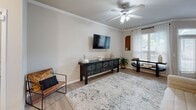 Located at 3101 Wells Branch Pkwy in Austin, TX, this thoughtfully designed one-bedroom, one-bathroom residence offers a comfortable and functional single-floor layout. The open-concept living room features light wood-look flooring, crown molding, a ceiling fan, and natural light filtering through blinds and sheer curtains, creating a bright and welcoming atmosphere. The adjacent dining area continues the airy feel with a large window, crown molding, and light-toned walls. The kitchen is well-equipped with dark espresso cabinetry, granite-style countertops, and a full suite of stainless steel appliances including a refrigerator, range, microwave, and dishwasher. The bedroom is carpeted for comfort, includes a ceiling fan and a generous window with natural light, and provides direct access to a spacious walk-in closet outfitted with wire shelving on multiple walls. A dedicated laundry area with a full-size washer and dryer is conveniently accessible from the bedroom. The bathroom features dark wood vanity cabinetry, granite countertops, a double sink, a large mirror with overhead lighting, and a shower-tub combination with light wood-look flooring throughout.