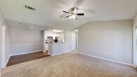 Located at 10100 Brown Bridge Road in Covington, Georgia, this single-floor, 2-bedroom, 2-bathroom residence offers a practical and comfortable layout designed for everyday living. The open-concept kitchen and living area serves as the heart of the home, where wood-style flooring flows throughout. The kitchen features white cabinetry, a peninsula countertop with a granite-style surface, and stainless steel appliances including a refrigerator and range. The living room is generously sized, fitted with plush carpeting, a ceiling fan, and multiple windows that fill the space with natural light, along with access to a private balcony overlooking lush green lawns and tree-lined surroundings. Both bedrooms are carpeted and equipped with ceiling fans, offering a cozy retreat, and each includes access to a dedicated closet. The primary bedroom features a spacious walk-in closet with wire shelving. The two bathrooms are finished with white cabinetry, granite-style countertops, wood-style flooring, and tiled shower-tub combinations with chrome fixtures. Throughout the residence, a neutral color palette and textured ceilings contribute to a clean, cohesive aesthetic.