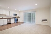 Located at 5196 Golden Rd in Pleasanton, CA, this well-appointed one-bedroom, one-bathroom residence offers a thoughtfully designed single-level layout. The open-concept living and dining area flows seamlessly into a fully equipped kitchen, which features crisp white shaker cabinetry with crown molding, dark quartz-style countertops, stainless steel appliances including a refrigerator, dishwasher, gas range, and built-in microwave, and warm hardwood-style flooring. Recessed lighting throughout the kitchen and living area creates a bright, inviting atmosphere, complemented by a sliding glass door that opens onto a private balcony with views of mature surrounding trees.

The bedroom is generously sized, finished with soft wall-to-wall carpeting, multiple windows with blinds that allow ample natural light, and a mirrored sliding-door closet that enhances the sense of space. An additional closet provides further storage convenience. The bathroom is clean and functional, featuring a tub/shower combination, wood-toned vanity, and hardwood-style flooring. A dedicated laundry area and hallway with additional closet space round out this efficiently arranged home, making it a practical and comfortable residence in the heart of Pleasanton.