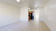 Located at 1935 S Sunnyvale in Mesa, AZ, this single-story, one-bedroom, one-bathroom residence offers a well-organized layout with a practical and comfortable design. The open-concept living and dining area is finished with light ceramic tile flooring and fitted with a ceiling fan, creating a bright and airy atmosphere. Large vertical blinds along the window allow for natural light while providing privacy. The galley-style kitchen is positioned adjacent to the living area and features warm wood cabinetry, dark granite-style countertops, a double-basin sink, and a full suite of black and stainless steel appliances, including a refrigerator, range, dishwasher, and microwave. Tile flooring continues seamlessly through the kitchen and hallway. The bedroom offers plush carpeting, a ceiling fan, and direct access to a private patio through a sliding glass door, allowing for natural light and outdoor connectivity. Two closets provide ample storage within the bedroom. A dedicated hallway connects the main living spaces to the bathroom and bedroom, maintaining a logical and efficient flow throughout the home. The patio offers an outdoor retreat, enclosed for added privacy — a fitting amenity for the Arizona lifestyle.