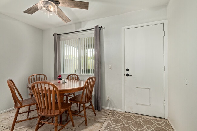 Dining room with backyard door and view of covered patio yard - 115 W 10th St