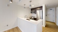 This 500 square foot apartment in Quincy, Massachusetts, offers a thoughtful blend of functionality and contemporary design. The one-bedroom, one-bathroom layout is efficiently arranged to maximize the available space. The kitchen is a standout feature, boasting modern stainless steel appliances, sleek dark cabinetry, and a white quartz countertop with an undermount sink. Pendant lighting adds a touch of sophistication to the space.

The living area is bright and airy, with light-colored walls and floors creating an open feel. Large windows in the bedroom allow natural light to flood the space, while providing views of the surrounding area. The bathroom is well-appointed with a modern vanity, large mirror, and spacious shower.

Throughout the apartment, the neutral color palette and clean lines contribute to a fresh, contemporary aesthetic. The use of materials such as wood-look flooring in the kitchen and plush carpeting in the bedroom adds warmth and comfort. Built-in closets and storage spaces help to keep the apartment organized and clutter-free.

Despite its compact size, this apartment offers all the essentials for comfortable urban living, making efficient use of every square foot. Its location at 1500 Hancock St places residents in the heart of Quincy, providing easy access to local amenities and transportation options.