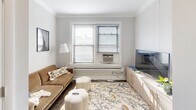 Located in Chicago's sought-after Lakeview neighborhood, this one-bedroom, one-bathroom home at 924 W Newport Ave offers a well-organized and efficiently designed layout across a single floor. The space makes smart use of every square foot, providing a comfortable and functional living environment.

The kitchen is a standout feature, outfitted with rich dark-wood cabinetry, granite-style countertops, and a full suite of stainless steel appliances including a refrigerator, range, microwave, and dishwasher. Dark hardwood flooring runs throughout, adding warmth and continuity. The adjoining dining area accommodates a bar-height table with seating, creating a casual and practical dining setup that flows naturally from the kitchen.

The living room is bright and welcoming, featuring a window that brings in natural light, crown molding along the ceiling, and hardwood floors that extend from the main living spaces.

The bedroom is a comfortable retreat with a ceiling fan, a sliding-door closet, and a window with natural light. With four closets distributed throughout the unit, storage is generous for a home of this size.

The bathroom features a tub-shower combination with a sink vanity. A hallway connects all rooms efficiently, keeping the layout cohesive. This home is ideal for those seeking a practical, move-in-ready space in a vibrant Chicago neighborhood.