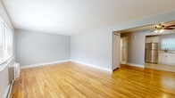 Located at 2 Lakeview Dr in Peekskill, NY, this single-floor, one-bedroom, one-bathroom residence offers a well-organized and efficiently designed layout. Warm-toned hardwood floors run throughout the living areas and bedroom, lending a cohesive and inviting feel to the entire space.

The living room is generously proportioned and bathed in natural light through large windows that frame views of the surrounding greenery. A dedicated dining area flows naturally from the living space, supporting a comfortable daily routine. The kitchen has been thoughtfully updated with white shaker cabinets, marble-style countertops, a subway tile backsplash, stainless steel appliances including a refrigerator and dishwasher, and light tile flooring — offering both style and functionality.

The spacious primary bedroom features hardwood floors, a baseboard heating system, and a window that provides natural light and outdoor views. Four closets distributed throughout the unit provide excellent storage capacity, a practical advantage in a compact residence.

The bathroom has been renovated to a clean, modern standard, showcasing marble-look tile flooring, a tiled tub-shower combination, a white vanity with marble-style countertop, and brushed bronze fixtures. Cool gray-toned walls throughout the home create a calm, neutral backdrop adaptable to a variety of interior styles.