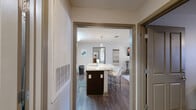 Located at 211 Kelly Rd in Clemson, SC, this well-appointed single-floor unit offers three bedrooms, four full bathrooms, and a thoughtfully designed layout that maximizes functionality. The open-concept kitchen and living area serves as the heart of the home, featuring dark cabinetry, stainless steel appliances, and a large granite-topped island with seating for multiple guests. The living room offers rich hardwood-style flooring and a bright, neutral palette that creates a welcoming atmosphere. Each bedroom is carpeted for comfort, with windows that invite natural light and views of the surrounding greenery. The primary bedroom includes a walk-in closet, while additional bedrooms offer closet space and ceiling fans. Four full bathrooms provide ample convenience, each featuring tub/shower combinations with clean, white finishes. A dedicated office with a ceiling fan and a window overlooking the outdoors offers a productive workspace. The in-unit laundry room is equipped with a full-size washer and dryer. Connecting hallways keep the layout organized and efficient, making this a practical and comfortable home in the heart of Clemson.