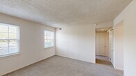 Located at 100 Park Blvd in Cherry Hill, NJ, this single-floor, 3-bedroom, 1-bathroom unit offers a practical and well-organized layout. The unit is finished throughout with neutral tones and textured ceilings, creating a clean and consistent aesthetic.

The kitchen features warm oak-toned cabinetry, granite-look countertops, and light hardwood-style flooring. It is equipped with a gas range, dishwasher, refrigerator, and a stacked washer and dryer unit tucked neatly into a dedicated alcove. Multiple windows allow natural light to fill the space.

The primary bedroom is the most spacious of the three, offering comfortable proportions, soft carpeting, a wide double-door closet, and a window with outdoor views. The two additional bedrooms are similarly finished with plush carpet, closets, and windows that bring in natural light — ideal for use as sleeping quarters, a home office, or a guest room.

The bathroom features a white vanity with under-cabinet storage, a mirrored medicine cabinet with multiple panels, and tile-accented walls, offering a tidy and functional design.

Two hallways connect the rooms, providing smooth circulation throughout the unit. The overall ambiance is bright, neutral, and move-in ready, making it a practical option in the Cherry Hill area.