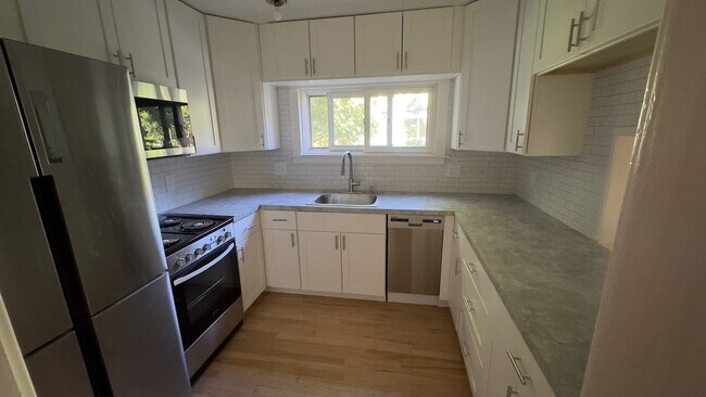 Kitchen with stainless steel appliances. Refrigerator is 4-door. - 1324 Wells St