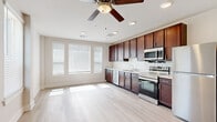 Located at 2116 N Memorial Way in Houston, TX, this studio offers a thoughtfully designed open-concept layout that maximizes every square foot of living space. Light-toned hardwood flooring runs throughout, complementing the crisp white walls and creating a bright, airy atmosphere. Multiple windows dressed with blinds allow generous natural light to fill the interior, while a ceiling fan with integrated lighting adds both comfort and functionality overhead.

The kitchen is a standout feature, equipped with rich dark-wood cabinetry extending floor to ceiling for ample storage. A classic white subway tile backsplash pairs with light countertops, and the suite of stainless steel appliances includes a dishwasher, range with oven, over-the-range microwave, and refrigerator — offering a fully functional cooking space.

The open living area flows seamlessly from the kitchen, providing a flexible space that can be arranged to suit a variety of needs. Recessed lighting and a ceiling fan keep the area well-lit and comfortable.

The bathroom features large-format tile flooring, a tiled tub and shower combination, a dark wood vanity with a white countertop, and brushed nickel grab bars, adding both practicality and a clean, modern finish to the space.