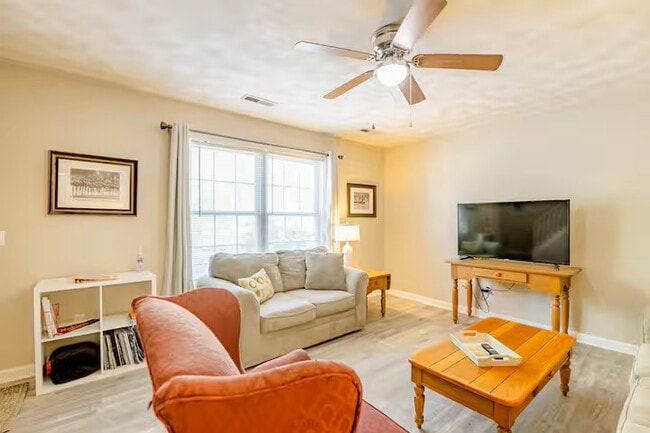 Living area has couch, love seat and arm chair with 50" smart tv. - 515 School Ln