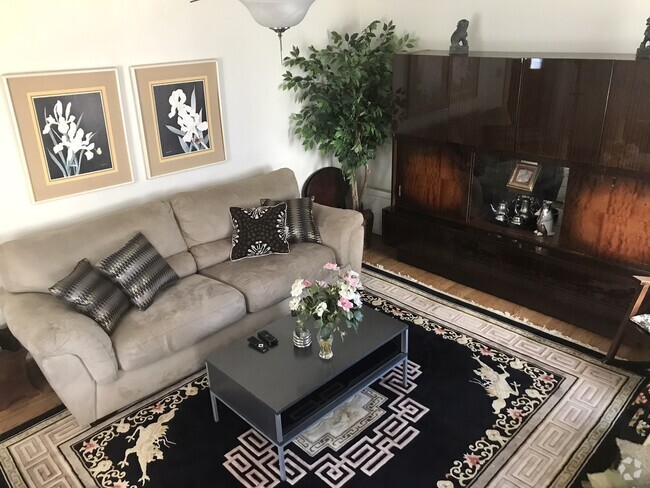 Modern living room with cozy couch and smart TV - 227 E Lamb St