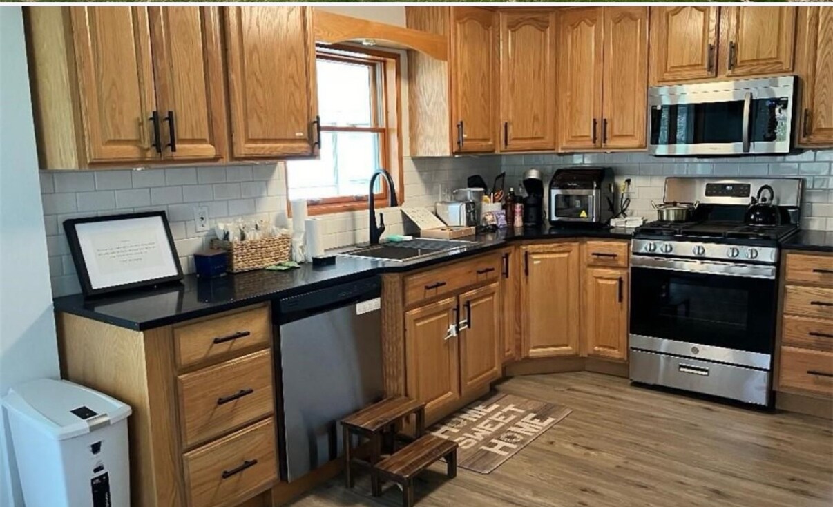 Newly renovated kitchen with granite countertops and all new appliances. - 22 Holt Rd