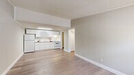Located in Temple Terrace, FL, this well-designed one-bedroom, one-bathroom unit offers a thoughtfully arranged floor plan that maximizes every inch of its compact footprint. Light-toned luxury vinyl plank flooring flows consistently throughout the space, complemented by neutral warm-gray walls, crisp white trim, and textured ceilings that tie the interior together cohesively.

The open living and kitchen area forms the heart of the unit. The kitchen is outfitted with white shaker-style cabinetry extending to the ceiling, a subway tile backsplash, a full suite of white appliances including a refrigerator, electric range, and integrated overhead lighting, creating a clean and functional cooking space. The adjacent living area offers an open, airy feel with easy sightlines throughout.

The bedroom is a comfortable, well-proportioned retreat featuring a ceiling fan with light fixture, a window that invites natural light, and durable wood-tone flooring in a slightly deeper finish. Crown molding and clean white baseboards add a refined touch throughout.

The bathroom is efficiently designed with a single vanity featuring white cabinetry, a full-width mirror, and a combined tub and shower enclosure. A utility room and hallway complete the layout, adding practical storage and flow. This unit delivers a clean, move-in-ready living experience.