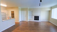 Located at 8000 W Crestline Ave in Denver, Colorado, this single-floor residence offers a welcoming and well-appointed living environment. The open-concept living area is a standout feature, showcasing rich hardwood flooring that extends throughout the space, lending warmth and a sense of continuity. Crown molding along the ceiling adds a refined architectural touch, complementing the clean, neutral wall tones that create a bright and airy atmosphere. A classic fireplace serves as the focal point of the living room, flanked by built-in shelving that provides both display space and functional storage. The thoughtful layout seamlessly connects the living area to the adjacent kitchen, which is partially visible and features a raised countertop bar — ideal for casual dining or entertaining. Natural light fills the space, enhancing the open feel of the interior. White interior doors and crisp baseboards contribute to the home's polished, move-in-ready aesthetic. The overall ambiance is one of comfort and understated elegance, making this Denver residence a practical yet inviting place to call home.