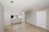 Located at 12400 Jefferson Hwy in Baton Rouge, Louisiana, this single-floor, 2-bedroom, 2-bathroom unit offers a well-organized layout designed for comfortable everyday living. The open living and dining area is anchored by light wood-style flooring that runs throughout the unit, complemented by neutral warm-gray walls and clean white trim. A textured ceiling adds dimension to the space, while a ceiling-mounted HVAC vent ensures efficient climate control.

The kitchen connects seamlessly to the living area via a pass-through counter with white countertops, providing both functionality and an open feel. Stainless steel appliances, including a full-size refrigerator, are included. The kitchen and living room share a cohesive, bright aesthetic.

The primary bedroom is a comfortable, well-proportioned room featuring a ceiling fan with light, a window for natural light, and direct access to a closet with built-in wire shelving for organized storage. The second bedroom also features a window and dedicated door access.

The two bathrooms are finished with matching light wood-style flooring, white fixtures, and clean, minimal design. The primary bath includes a vanity with gray cabinetry and a white countertop, while the second bath features a full soaking tub and shower combination. Both bathrooms maintain a fresh, functional aesthetic consistent with the rest of the unit.