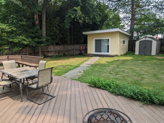 Back yard deck, with gravel walkway to detached office / gym. Deck furniture included. - 7605 Fisher Dr
