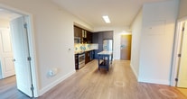 This contemporary apartment, located at 8300 Wisconsin Ave in Bethesda, MD, offers 1040 square feet of well-designed living space. The single-story layout comprises four bedrooms, including a primary bedroom of 160 square feet, and two full bathrooms. The heart of the home is a modern kitchen, featuring dark wood cabinetry, stainless steel appliances, and a striking granite-topped island. The living room is spacious and filled with natural light, thanks to large windows that offer views of the surrounding area. Throughout the apartment, you'll find high-quality finishes such as wood-look flooring and neutral-toned walls. The bathrooms are tastefully appointed with modern fixtures and ample counter space. A notable feature is the abundance of storage, with two dedicated closet spaces. The apartment's design emphasizes open spaces and a seamless flow between rooms, creating an inviting and functional living environment perfect for contemporary urban life.