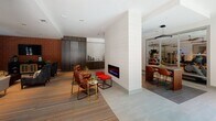 Located at 1743 Central Park Rd in Charleston, SC, this single-floor community amenity space is thoughtfully designed to offer both comfort and functionality. The layout flows seamlessly across distinct zones, each serving a unique purpose while maintaining a cohesive, contemporary aesthetic throughout.

The lounge area is anchored by plush seating arrangements, including richly upholstered armchairs and a neutral-toned sofa, set atop vibrant striped carpeting that adds warmth and visual interest. A striking textured accent wall in warm copper tones provides a bold contrast to the neutral gray palette of the surrounding walls and ceilings. Floor-to-ceiling windows dressed with elegant gray drape curtains invite abundant natural light and frame views of the lush surrounding tree canopy.

A central fireplace feature serves as a focal point, flanked by leather lounge chairs and vibrant red accent ottomans, creating an intimate gathering nook. Adjacent to this is a well-appointed business center with a long wooden desk, bar-height seating, and multiple computer workstations, ideal for remote work or study.

The space also includes a dining counter with bar seating, a kitchenette area, and easy access to an outdoor area through glass-paneled double doors. Large-format tile flooring transitions smoothly between functional zones. The overall ambiance is modern, inviting, and well-suited for community gatherings and everyday use.