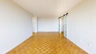 This 840 square foot apartment in Toronto offers a blend of comfort and modern design. The space is efficiently laid out with two bedrooms, including a primary bedroom of 190 square feet, and one bathroom. The living areas are characterized by beautiful parquet flooring, which adds warmth and elegance to the space.

Large windows are a prominent feature, allowing ample natural light to flood the rooms and providing scenic city views. The modern kitchen is equipped with white cabinetry, ample counter space, and essential appliances, including a stove and range hood. The bathroom features a clean, contemporary design with a bathtub and shower combination.

The apartment includes a balcony, offering an outdoor extension to the living space. The interior is painted in neutral tones, creating a bright and airy atmosphere throughout. Sliding glass doors in the living area lead to the balcony, enhancing the connection between indoor and outdoor spaces.

The layout includes a hallway and closet space, ensuring practical storage solutions. The overall design of the apartment emphasizes openness and functionality, making efficient use of the 840 square feet. Located at 2085-2101 Islington Ave in Toronto, this single-floor apartment combines urban living with comfortable, well-designed interiors.