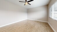 Located at 11819 Eucalyptus Ave in Hawthorne, CA, this efficiently designed one-bedroom, one-bathroom single-floor home offers a thoughtful layout that maximizes every square foot. The open living area features light wood-style tile flooring, neutral warm-toned walls, and a ceiling fan, creating a bright and airy atmosphere. Natural light flows in through wide windows dressed with white horizontal blinds. The kitchen is well-appointed with white shaker cabinets, gray quartz-style countertops, stainless steel appliances including a gas range and over-the-range microwave, and a peninsula that provides additional prep and serving space. Wood-style flooring continues seamlessly through the kitchen and living areas for a cohesive look. The bedroom is comfortably sized, featuring plush carpeting, a ceiling fan with light fixture, a wide window with outdoor views, and a closet with additional storage provided by a second closet nearby. The bathroom offers a tub-shower combination enclosed by a sliding glass door, with elegant marble-look tile surround adding a refined touch. A hallway connects the spaces efficiently, completing this clean and move-in-ready home.