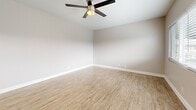 Located at 11819 Eucalyptus Ave in Hawthorne, CA, this efficiently designed one-bedroom, one-bathroom single-floor home offers a thoughtful layout that maximizes every square foot. The open living area features light wood-style tile flooring, neutral warm-toned walls, and a ceiling fan, creating a bright and airy atmosphere. Natural light flows in through wide windows dressed with white horizontal blinds. The kitchen is well-appointed with white shaker cabinets, gray quartz-style countertops, stainless steel appliances including a gas range and over-the-range microwave, and a peninsula that provides additional prep and serving space. Wood-style flooring continues seamlessly through the kitchen and living areas for a cohesive look. The bedroom is comfortably sized, featuring plush carpeting, a ceiling fan with light fixture, a wide window with outdoor views, and a closet with additional storage provided by a second closet nearby. The bathroom offers a tub-shower combination enclosed by a sliding glass door, with elegant marble-look tile surround adding a refined touch. A hallway connects the spaces efficiently, completing this clean and move-in-ready home.