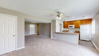Located at 59 Port Ocall Dr in Indianapolis, Indiana, this two-story home offers 2 bedrooms and 3 bathrooms thoughtfully distributed across two floors of comfortable living space. The main floor hosts an open-concept kitchen and living area, with the kitchen featuring warm wood cabinetry, stone-look countertops, light hardwood-style flooring, and a window that draws in natural light. The living room extends generously from the kitchen, finished with neutral carpet, a ceiling fan, and a welcoming front entry. A dedicated laundry room with washer and dryer hookups adds everyday convenience on this level. Upstairs, the two bedrooms are carpeted and finished in soft neutral tones, each equipped with ceiling fans and ample closet space fitted with wire shelving systems. The spacious primary bedroom provides a comfortable retreat. Three full bathrooms serve the home, including one with a full tub-shower combination. Throughout, clean white trim, neutral gray wall tones, and consistent flooring choices create a cohesive, move-in-ready aesthetic. A hallway connects the upper-level rooms, and a staircase with wood railing links both floors. The home's straightforward layout and practical finishes make it a functional and comfortable residence.