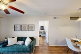 This well-appointed one-bedroom, one-bathroom unit in Houston, TX offers a thoughtfully organized layout across a single floor. The living room serves as the heart of the space, featuring wood-look flooring, a ceiling fan, and a pair of French doors that flood the room with natural light and open onto a private balcony — ideal for outdoor relaxation. The adjacent dining area flows seamlessly into the galley-style kitchen, which is outfitted with gray shaker cabinetry, white quartz countertops, a classic subway tile backsplash, stainless steel appliances, and a double-basin sink. The bedroom is a calm retreat, highlighted by a ceiling fan, a large window framing views of the surrounding greenery, and direct access to a closet. The bathroom features a clean, tiled tub-shower combination in a crisp white finish. Throughout the unit, warm wood-look flooring ties the rooms together, while neutral wall tones create a bright and welcoming ambiance. The space also includes an unclassified room suitable for a home office or additional storage. Situated in the Jones Road corridor of northwest Houston, this unit combines functional design with comfortable everyday living.