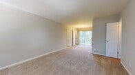 Located at 4883 Roswell Rd NE in Atlanta, Georgia, this single-floor residence offers four bedrooms, one bathroom, a kitchen, hallway, and entrance within a thoughtfully laid-out floor plan. Neutral-toned carpet runs throughout the living and bedroom areas, contributing to a clean, cohesive aesthetic. The spacious primary bedroom is notably generous in size and is enhanced by a sliding glass door that fills the room with natural light and offers views of surrounding greenery. Additional bedrooms are carpeted and finished with soft gray walls, with some rooms featuring ceiling fans and windows that allow in natural light. The kitchen is a functional highlight, showcasing rich dark wood cabinetry, a light gray subway tile backsplash, granite countertops, a central island with matching cabinetry, wood-look flooring, and black appliances. A window above the sink brings in additional daylight. The bathroom features a clean, white-tiled tub and shower surround, maintaining a simple and classic design. Throughout the unit, white trim and soft neutral wall colors create a bright, welcoming atmosphere. The overall layout is efficient and practical, making this residence a well-organized and comfortable living space in the heart of Atlanta.