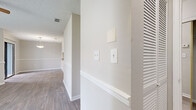 This single-story, 1-bedroom, 1-bathroom unit offers a thoughtfully designed layout that maximizes its compact footprint. The combined kitchen and living area serves as the heart of the home, where wood-look laminate flooring, a textured ceiling, and a ceiling fan create a comfortable, casual ambiance. A tile-surround fireplace anchors the living room, complemented by a large window that invites natural light and outdoor views. A pass-through window with a bar ledge connects the living area to the kitchen, enhancing the open feel. The kitchen is outfitted with white cabinetry, granite-look countertops, a subway tile backsplash, stainless steel appliances, and tile flooring — offering both style and functionality. The hallway, accented by crisp white wainscoting, leads to the remaining rooms. The bedroom is a comfortable, carpeted retreat featuring a ceiling fan and a window with outdoor views. The bathroom features a white vanity with a granite-look countertop, tile flooring, a well-lit mirror, and a shower/tub combination. Additional practical spaces include a dedicated laundry room with washer hookups and wood-look flooring, as well as a closet for ample storage. Throughout, neutral tones and clean finishes give the space a bright, move-in-ready character.