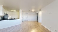 Located at 5700 W 6th St in Los Angeles' vibrant Miracle Mile neighborhood, this 2-bedroom, 2-bathroom unit offers a well-designed single-level layout with a clean, modern aesthetic. The open-concept living area features light hardwood-style flooring, crisp white walls, and a track lighting fixture, creating a bright and welcoming atmosphere. Large windows allow natural light to fill the space, enhancing the airy feel throughout.

The kitchen is thoughtfully appointed with white shaker cabinetry, dark countertops, a mosaic tile backsplash, a built-in wine rack, and a full suite of stainless steel appliances including a range, microwave, and refrigerator. It opens directly to the living area via a peninsula counter, making it ideal for everyday living and entertaining.

Both bedrooms are carpeted and well-proportioned, with windows providing natural light and views of the surrounding neighborhood. The primary bedroom offers a generous footprint with ample closet space. The unit includes five closets in total, providing excellent storage throughout.

The two bathrooms are finished with tile flooring and mosaic accent details. One features a glass-enclosed shower with dark countertops, while the other offers a full tub-and-shower combination. Hallways connect the rooms efficiently, completing this functional and stylish Los Angeles residence.