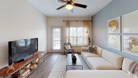 Located at 815 Willow Wood Ln in Rock Hill, South Carolina, this single-floor residence offers a thoughtfully designed layout with comfortable living spaces throughout. The living room is bright and welcoming, featuring wood-look flooring, a ceiling fan, and large windows with a glass door that invite natural light and provide views of the surrounding community. The open-concept kitchen is well-equipped with light wood cabinetry, granite-style countertops, stainless steel appliances including a refrigerator, gas range, and microwave, along with a double sink and a convenient breakfast bar. A dedicated dining area sits adjacent to the kitchen. The bedrooms are generously sized, each with plush carpeting, ceiling fans, and large windows that allow ample natural light. Warm accent walls add character to the primary bedroom spaces. The bathrooms are well-appointed with light wood vanities, granite-style countertops, and wood-look flooring. One bathroom features a single vanity with ample mirror space, while the second includes a full tub-shower combination. A laundry area is also accessible within the unit. The overall ambiance is clean, modern, and functional, making this a comfortable and practical home.