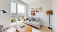 Located at 355 Glendale Blvd in the vibrant Echo Park neighborhood of Los Angeles, this modern one-bedroom, one-bathroom unit offers a well-designed layout across a single floor. The living room is bathed in natural light through large floor-to-ceiling windows that frame sweeping views of the surrounding Los Angeles cityscape, creating an open and airy atmosphere. Light hardwood flooring runs throughout the unit, contributing to a clean, contemporary aesthetic. The kitchen is outfitted with stainless steel appliances, including a full-size refrigerator, range, dishwasher, and microwave, complemented by sleek white upper cabinetry, gray lower cabinets, a bold navy blue subway tile backsplash, and light quartz countertops. A dedicated dining area sits adjacent to the kitchen. The bedroom is a bright, comfortable retreat featuring a large sliding glass door that opens directly onto a private balcony with glass railings and panoramic views of the LA skyline and tree-lined streets below. The bathroom features clean white tile, a tiled walk-in shower, and modern black hardware accents. The private balcony serves as a standout feature, offering an elevated outdoor space ideal for enjoying the Southern California climate.