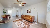 Located on Harvey Mitchell Parkway South in College Station, Texas, this single-story, two-bedroom, one-bathroom unit offers a efficiently designed layout across a compact but functional floor plan. The living room serves as the central gathering space, featuring light-toned wood-look flooring, a ceiling fan with integrated lighting, and a front-facing window with horizontal blinds that allow natural light to filter in. The room connects smoothly to the hallway, which leads to the remaining areas of the unit.

The galley-style kitchen is lined with white cabinetry on both sides, offering ample storage alongside light-toned countertops. White appliances, including a refrigerator, dishwasher, and electric range, are integrated throughout. A window at the end of the kitchen provides additional natural light.

Both bedrooms are carpeted and equipped with ceiling fans. The primary bedroom offers a comfortable footprint with a window providing natural light and wall space suited for various furniture arrangements. The second bedroom, slightly more compact, also includes carpet flooring and a ceiling fan, making it adaptable as a guest room or home office.

The bathroom features a full tub-shower combination with a curtain rod, a toilet, and wood-look flooring, finished in a clean, neutral palette throughout.