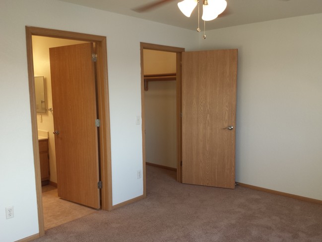 Master Bedroom with Attached Bathroom and Walk-in Closet - Oklahoma Park Townhomes