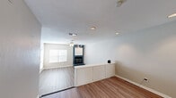 This single-story, 2-bedroom, 2-bathroom home offers a functional and comfortable layout designed for practical living. The open living area is a standout feature, showcasing light wood-look flooring, a textured ceiling, recessed lighting, and a ceiling fan. A bold slate-blue fireplace with a decorative surround serves as a focal point, adding character to the space. A built-in white storage cabinet provides additional organization, while a window allows natural light to filter in.

The galley-style kitchen is efficiently designed with white cabinetry, dark granite-style countertops, black appliances including a refrigerator, electric range, and microwave, along with a double sink and a window for added brightness.

Both bedrooms are carpeted and include ceiling fans for comfort. The primary bedroom features a spacious walk-in closet with built-in shelving and hanging rods, offering generous storage. The second bedroom also includes closet access. The two bathrooms are functional in design, with one featuring over-toilet cabinetry for extra storage. Throughout the home, neutral tones and clean finishes create a cohesive, move-in-ready atmosphere well-suited for a variety of lifestyles.