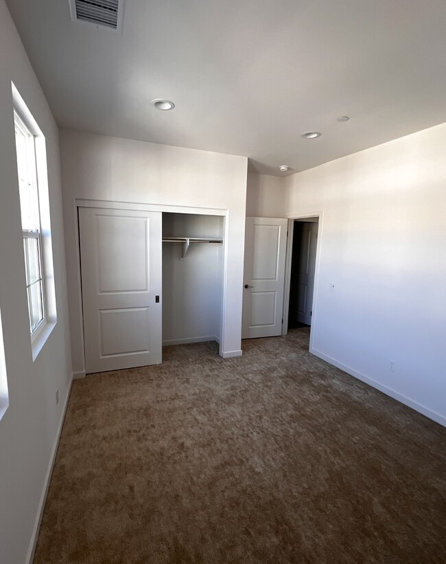 This is an image of the room displaying the closet and entrance door - 18122 Radiance Ln