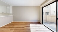 Located at 101 Bridewell St in the Highland Park neighborhood of Los Angeles, this one-bedroom, one-bathroom unit offers a practical and well-organized single-floor layout. The open-concept kitchen and living area provides a seamless flow, with the kitchen featuring white cabinetry, light countertops, white tile flooring, and appliances including a range, dishwasher, and refrigerator. A dedicated pantry provides additional storage. The living room is bright and airy, filled with natural light streaming through large sliding glass doors that open to a private outdoor space. Warm wood-look flooring runs throughout the living, dining, and bedroom areas, complementing the neutral, beige-toned walls and textured ceilings. A separate dining room adds structure to the layout, while a dedicated living room offers a comfortable, defined gathering area. The bedroom is generously sized, featuring two mirrored sliding-door closets that enhance the sense of space and light, along with natural light from a window. The bathroom is clean and straightforward, with white tile flooring, a vanity with storage, and a shower-tub combination. Two closets throughout the unit offer ample storage for everyday living.