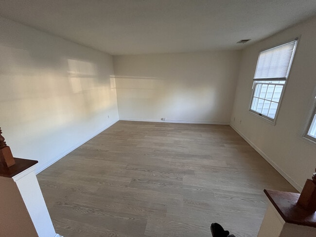 Living room at front of the house, with new LVT flooring and lots of natural light - 9908 Whitney Cir