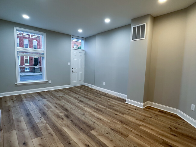 Living room with high ceilings and ample lighting. - 2208 Orleans St