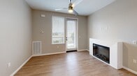 Located at 1113 Baywood Dr in Petaluma, CA, this well-appointed 2-bedroom, 2-bathroom single-story home offers a thoughtfully designed open-concept layout. Light wood-tone flooring flows throughout the main living areas, creating a warm and cohesive aesthetic. The combined kitchen and dining area serves as the heart of the home, showcasing contemporary flat-front wood cabinetry, a marble-look quartz waterfall island, pendant lighting, a full suite of stainless steel appliances, and a classic subway tile backsplash. A dedicated pantry provides additional storage convenience. The living room is bright and inviting, featuring a modern fireplace, a ceiling fan, and a glass door that opens to a private outdoor area, allowing natural light to fill the space. Both bedrooms are carpeted for comfort, with neutral tones and windows that let in natural light. Each bedroom benefits from dedicated closet space, including a walk-in closet with built-in shelving and hanging rods. The two bathrooms are clean and functional, with one featuring a full tub-shower combination. An in-unit laundry area adds everyday practicality to this move-in-ready home.