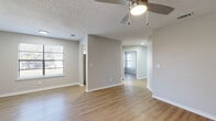 Located at 2639 Granada Bay Dr in Melbourne, FL, this single-floor, 2-bedroom, 1-bathroom residence offers a clean, modern aesthetic throughout. Light-toned luxury vinyl plank flooring flows seamlessly across every room, complemented by neutral gray walls, crisp white baseboards, and textured ceilings that add architectural character.

The open living area is bright and airy, benefiting from multiple windows with blinds that invite natural light. A ceiling fan with an integrated light fixture provides both comfort and functionality. The layout connects effortlessly to a hallway that leads to the rest of the home.

The kitchen is thoughtfully appointed with white shaker-style cabinetry, light quartz countertops, a stainless steel sink, and a full suite of stainless steel appliances including a range, microwave, and dishwasher — all set against a clean white backsplash.

The spacious primary bedroom offers a generous footprint with a large window framing outdoor views. The second bedroom is equally well-sized and also features natural light through a window. A dedicated closet provides additional storage.

The full bathroom features tile-surround tub/shower combination with a curved curtain rod, a white vanity with ample counter space, and wood-look flooring, creating a clean, functional space. A central hallway ties all rooms together for a well-organized flow throughout the home.