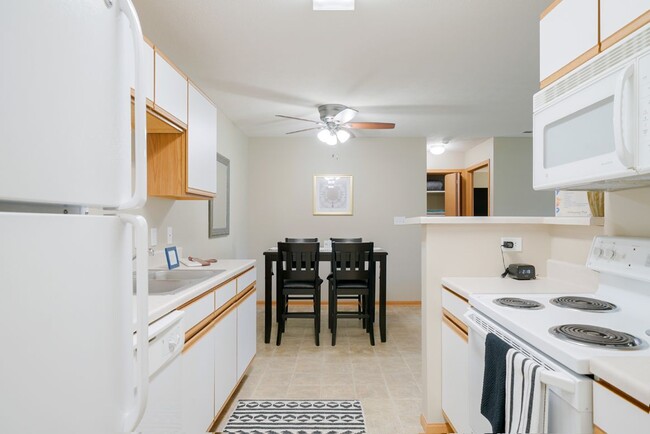 Tradition kitchen with white appliances in the James River floor plan. - Williamsburg Park Apartments