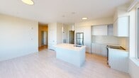 This well-appointed 2-bedroom, 2-bathroom residence in Weymouth, MA offers a thoughtfully designed single-level layout with modern finishes throughout. The open-concept kitchen serves as the heart of the home, featuring a central island with a built-in sink, sleek flat-panel cabinetry, stainless steel appliances, and a herringbone-pattern tile backsplash. Light wood-look flooring flows through the kitchen and into the adjacent living area, which is brightened by multiple large windows offering pleasant outdoor views. The spacious primary bedroom provides generous room for furnishings, complete with dual closets offering ample storage. The second bedroom is equally well-sized with large windows that invite abundant natural light and outdoor views. Both bathrooms are finished with neutral large-format floor tiles and taupe wall tile surrounds — one featuring a soaking tub with a sliding glass enclosure, and the other a walk-in shower. Clean white walls, recessed and pendant lighting, and crisp trim details contribute to a bright, contemporary ambiance. A dedicated closet adds further storage convenience, rounding out this clean and functional Weymouth residence.