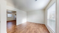 Located at 190 Rue Sans Souci in Bethalto, Illinois, this two-floor home offers a clean, move-in-ready interior defined by warm hardwood-style flooring that runs consistently throughout every room, creating a cohesive and inviting atmosphere. The layout flows naturally between living and functional spaces, with crisp white walls and neutral tones providing a bright, airy feel across both floors.

The kitchen is well-appointed with ample cabinetry in a neutral taupe finish, a double-basin sink, light-toned countertops, and white appliances including a refrigerator and electric range. A window in the kitchen area brings in natural light and provides a view of the surroundings. Adjacent spaces offer generous room for dining and everyday living, with open sightlines connecting the kitchen to the main living area.

Throughout the home, the individual rooms are generously proportioned, featuring clean walls and windows fitted with blinds that allow for natural light while maintaining privacy. The full bathroom includes a tub-shower combination, a toilet, and a white vanity with storage, all finished in a clean, neutral palette. A staircase connects the two floors, and the overall layout — as visible in the dollhouse view — makes efficient use of the available space across both levels.