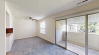 Located at 2402 Flint Dr in Wilmington, NC, this single-floor, two-bedroom, one-bathroom residence offers a practical and comfortable layout. The interior is finished with neutral, light-toned walls throughout, creating a clean and bright atmosphere.

The kitchen is well-appointed with white cabinetry, light countertops, a double stainless steel sink, a tile mosaic backsplash in warm earth tones, a dishwasher, and an electric range — providing a functional cooking space with classic appeal.

Both bedrooms feature soft wall-to-wall carpeting and ceiling fans with light fixtures, contributing to a comfortable environment year-round. The primary bedroom stands out with a sliding glass door that opens directly onto a private balcony, allowing for natural light and outdoor access. The second bedroom includes a dedicated closet with built-in shelving, offering practical storage. An additional closet space is accessible from the hallway, further enhancing storage options.

The bathroom features a vanity with sink and textured walls. A connecting hallway ties the rooms together efficiently. The private balcony adds a pleasant outdoor retreat. Overall, this residence presents a straightforward, functional living space well-suited for everyday comfort in Wilmington, NC.