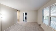 Located at 1905 Richardson Place Dr in Arnold, Missouri, this single-floor, two-bedroom, one-bathroom residence offers a practical and comfortable layout. The living room provides a carpeted, open space with neutral-toned walls and a front entry door flanked by a window that draws in natural light. A hallway connects the main living area to the rest of the home. The kitchen is well-equipped with dark espresso cabinetry, stainless steel appliances including a refrigerator, range, over-the-range microwave, and dishwasher, complemented by a double-basin sink, light countertops, and wood-look vinyl flooring. A ceiling fan with lighting adds functionality to the kitchen space, while multiple windows provide natural light and outdoor views. Both bedrooms feature soft carpet flooring and neutral walls, with each room offering a window with outdoor views. The primary bedroom includes generous closet space with sliding doors, while the second bedroom also features built-in closet storage. The bathroom is clean and functional, with a full tub-shower combo, a white vanity with storage, and wood-look flooring that ties the space together cohesively.