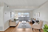 Located at 1420 Chaffee Street in Upland, California, this single-story 2-bedroom, 2-bathroom residence offers a thoughtfully designed layout that maximizes its efficient footprint. The living room serves as the heart of the home, featuring warm wood-style flooring, a textured ceiling, and a sliding glass door that fills the space with natural light and provides outdoor access. A ceiling fan and open sightlines connect the living area to a dedicated dining space, creating a cohesive and functional common area. The kitchen is fitted with white cabinetry, granite-look countertops, a double basin sink, a gas range, and a dishwasher, offering practical utility in a clean, bright setting. Both bedrooms are carpeted and feature large windows that invite natural light, as well as built-in closets with shelving for ample storage. The generously sized primary bedroom includes a well-organized closet and a peaceful, restful ambiance. Each of the two bathrooms is finished with a tub-shower combination, granite-look vanity countertops, and wood-style flooring, maintaining a consistent, clean aesthetic throughout. A connecting hallway ties all rooms together, contributing to a smooth and efficient flow across the entire residence.